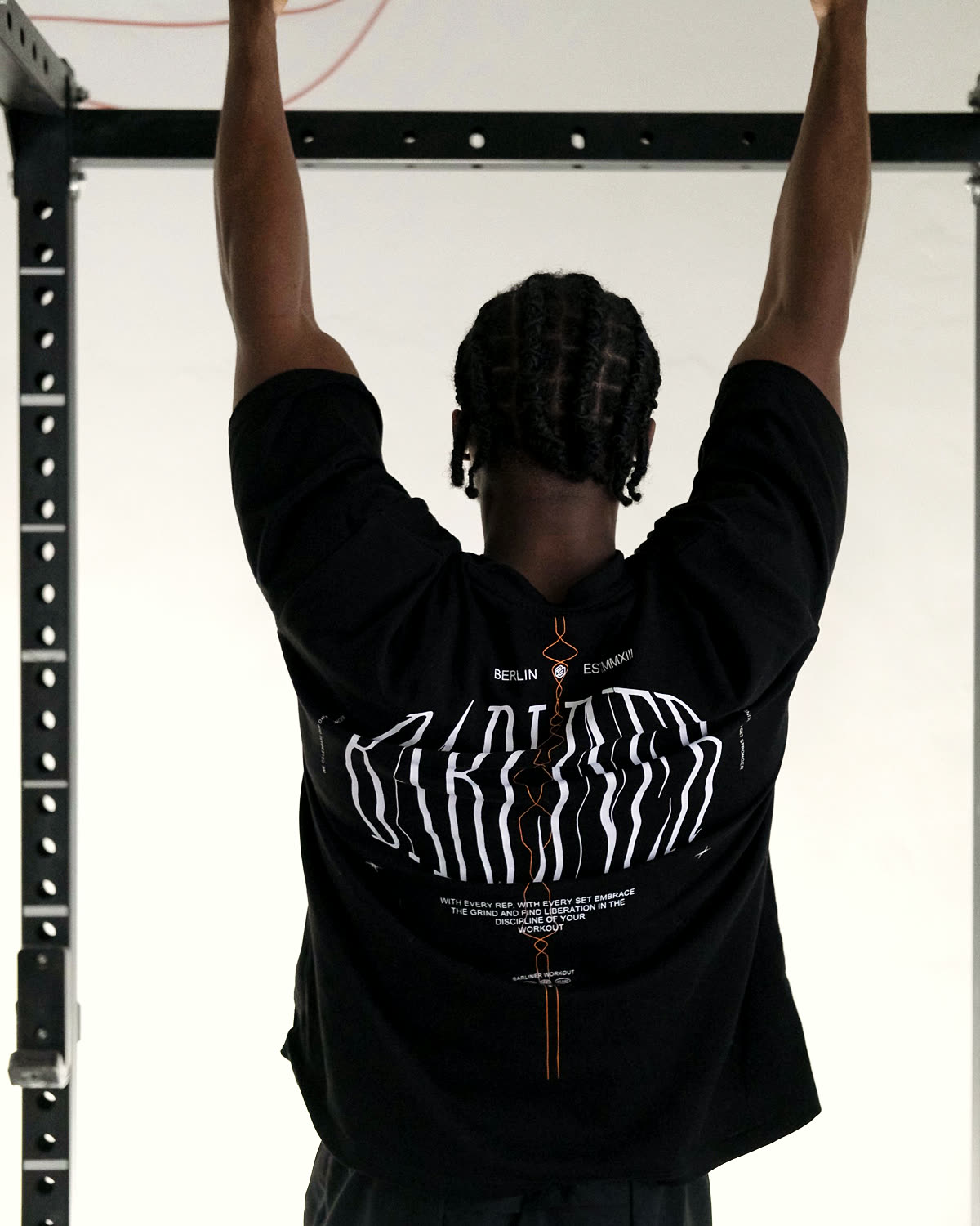 The black Barliner T-shirt from the back, hanging from the bar